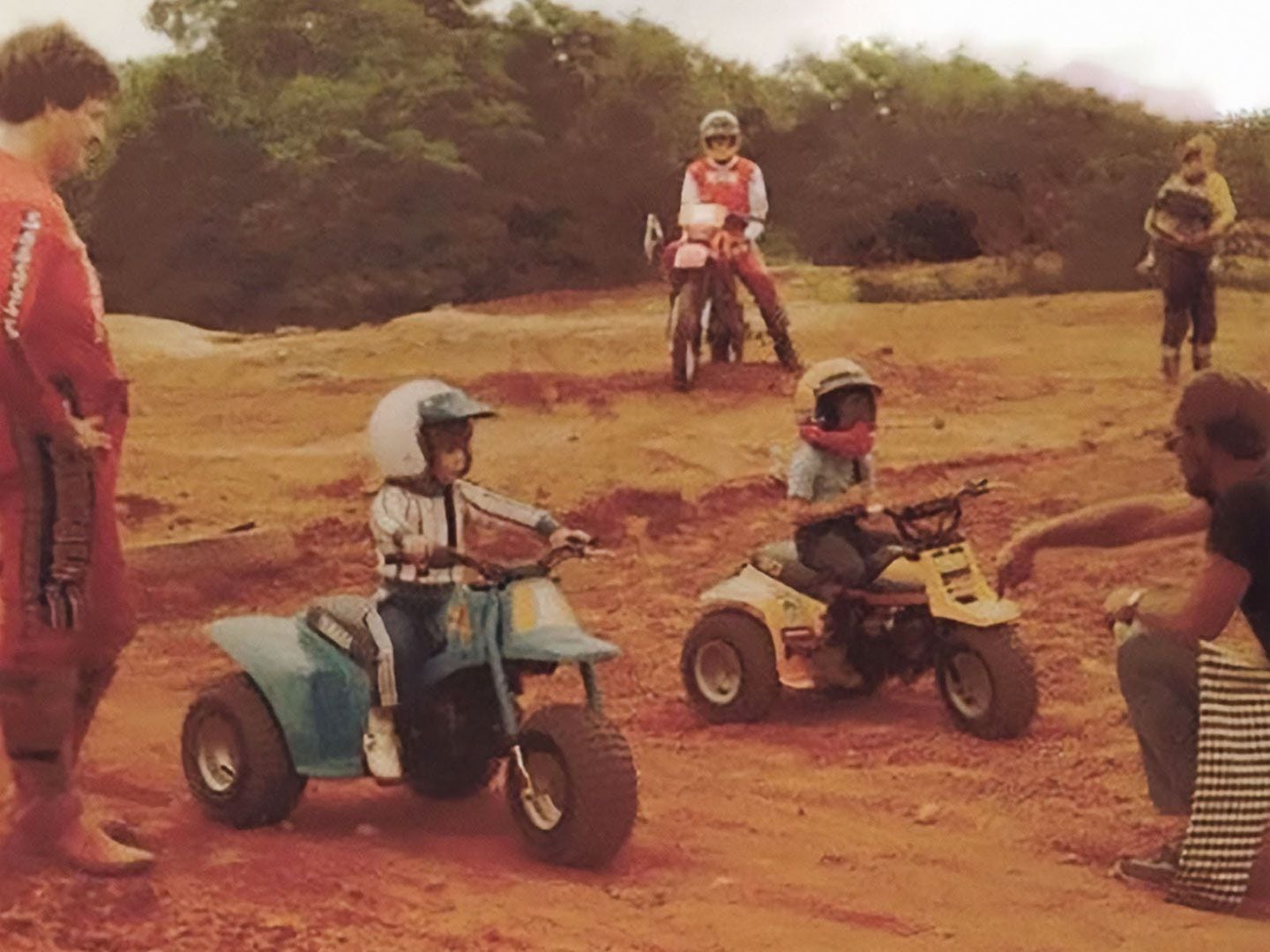 Eric Osner (left) with friends and a young Mariel tearing it up on the track in the 1970s on three-wheelers.