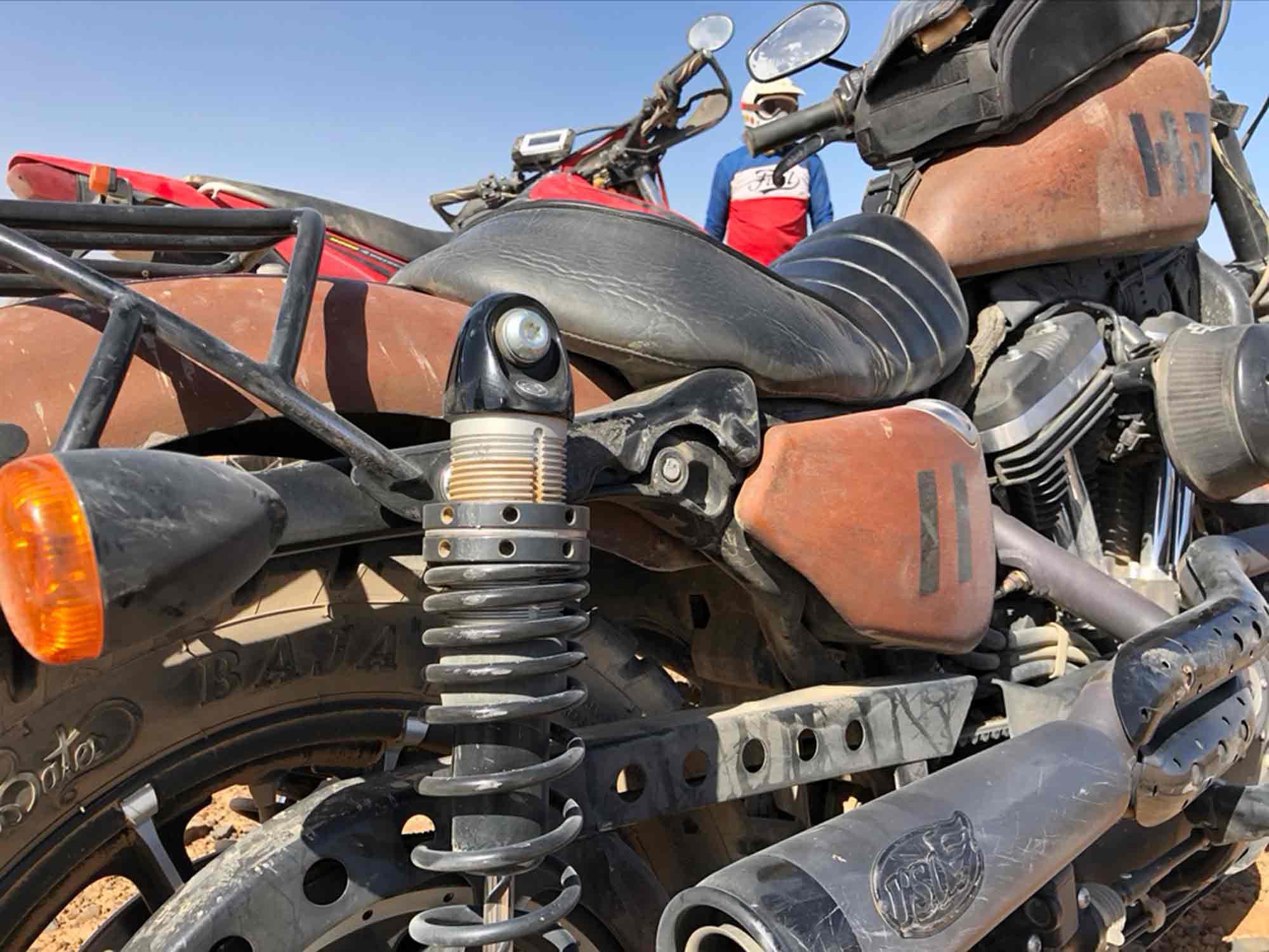 The right-side shock on my Sportster after shearing its mounting bolt clear off.