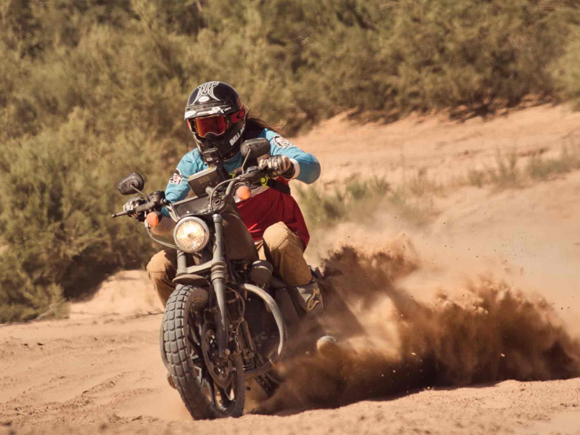 The back tire spitting out clouds of red sand, keeping the front tire barely above it. Pinned in third gear, I make it through the fesh-fesh.