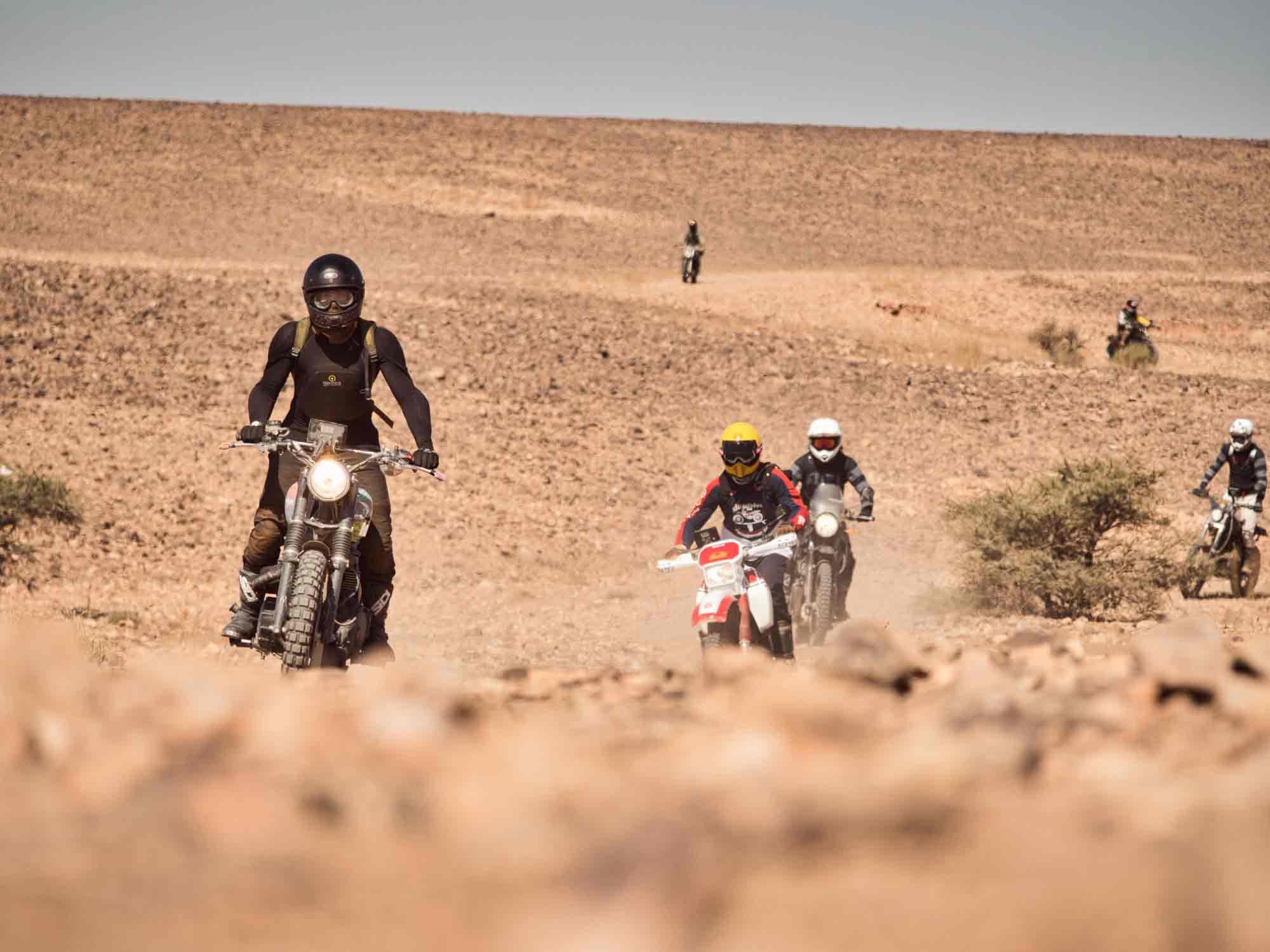 Fast Eddie on his Triumph, followed by a vintage Ténéré, a custom XR650, and an SR500.